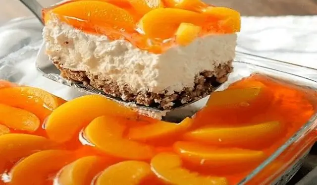 Прохладный и вкусный десерт из холодильника, с бисквитной основой, воздушным кремом и персиково-желейной глазурью